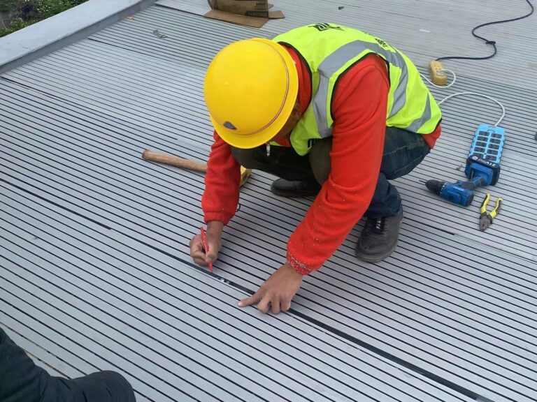 Workers installing materials on site